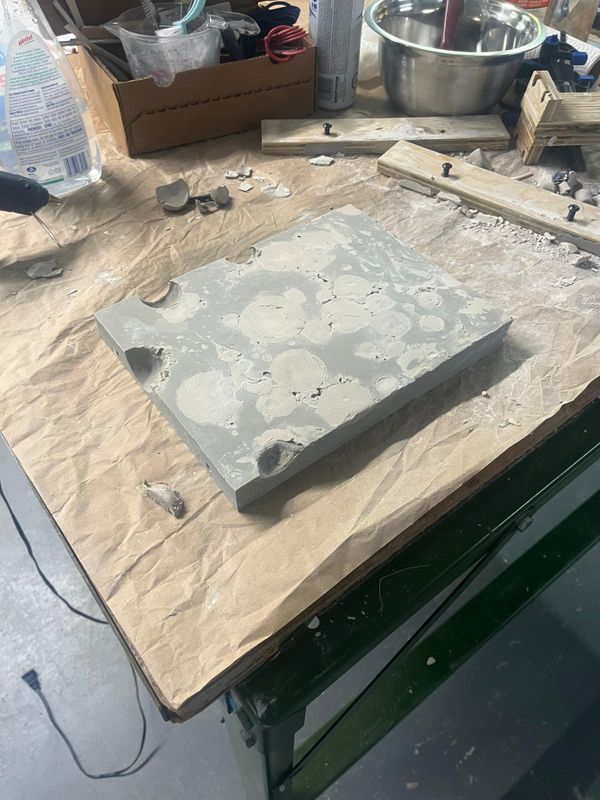 Once the Ultracal has cured, the clamps can be removed and the piece removed from the plywood mold. You can see the soft clay that will need to be painstakingly removed.